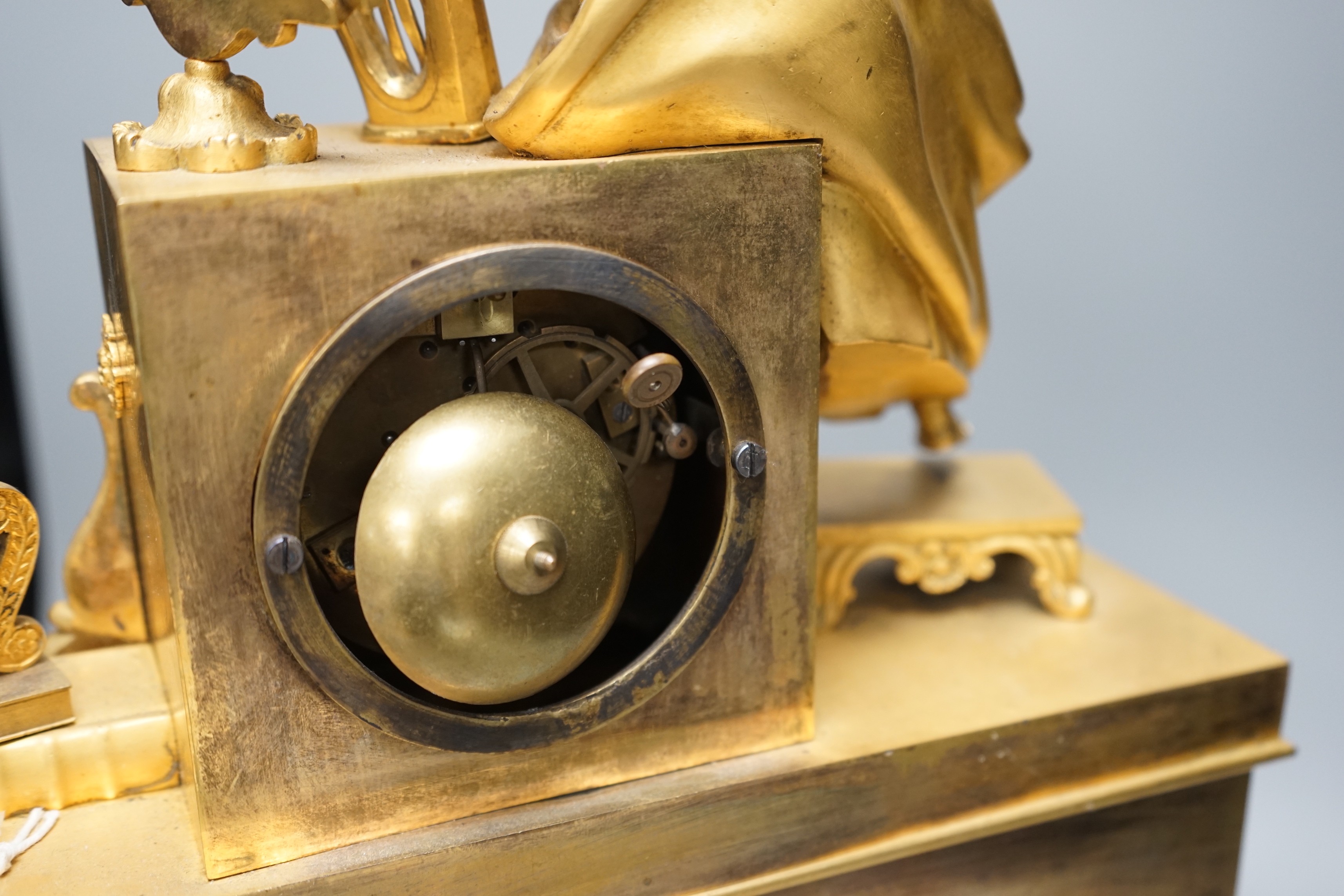 A 19th century French ormolu mounted clock with seated female Harpist decoration, with key, 49cm tall